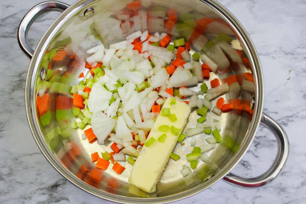 sauteeing carrot, onion, and celery in a dutch oven.