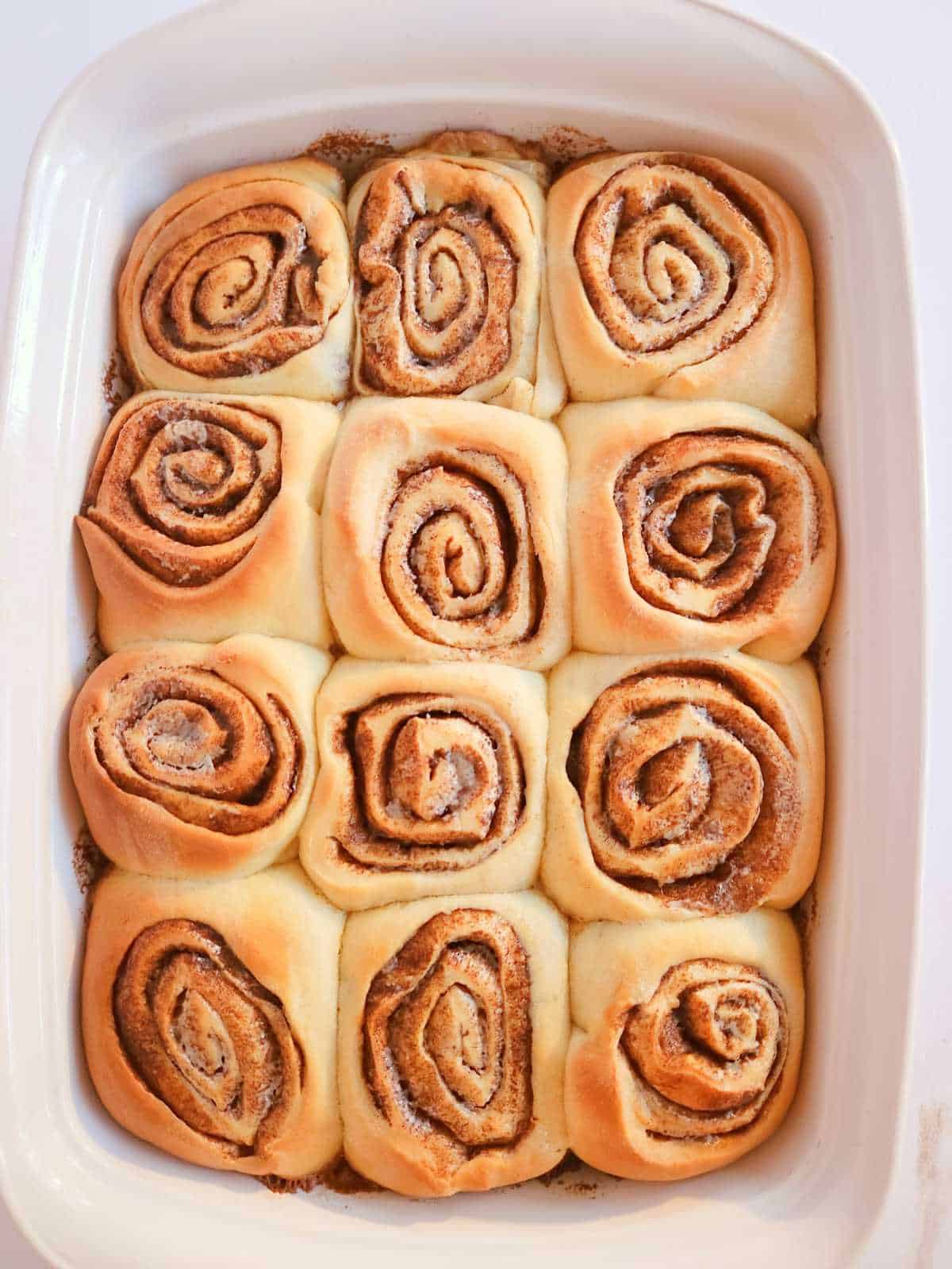 baked cinnamon rolls in a baking dish.