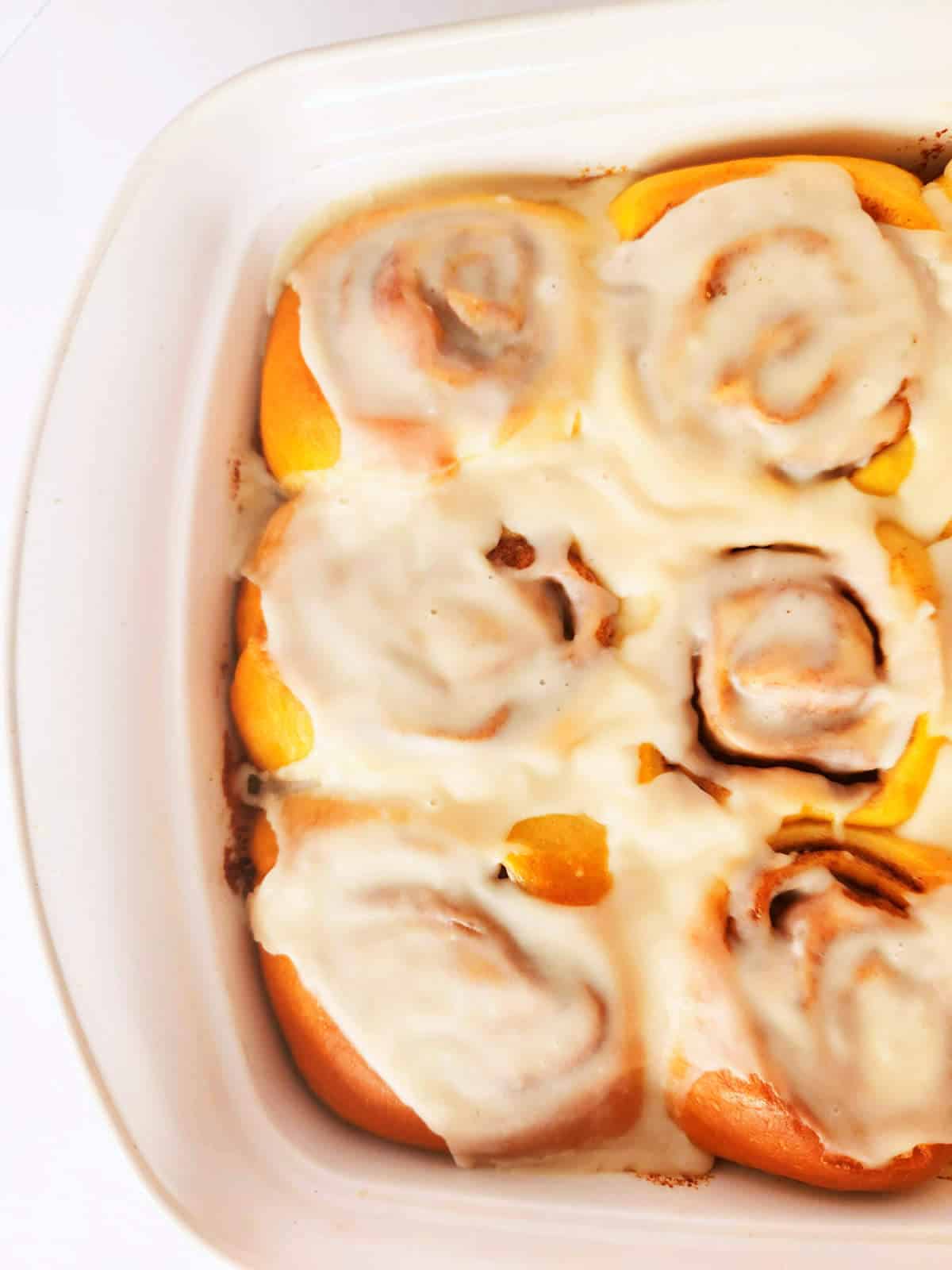 baked cinnamon rolls in a baking dish.