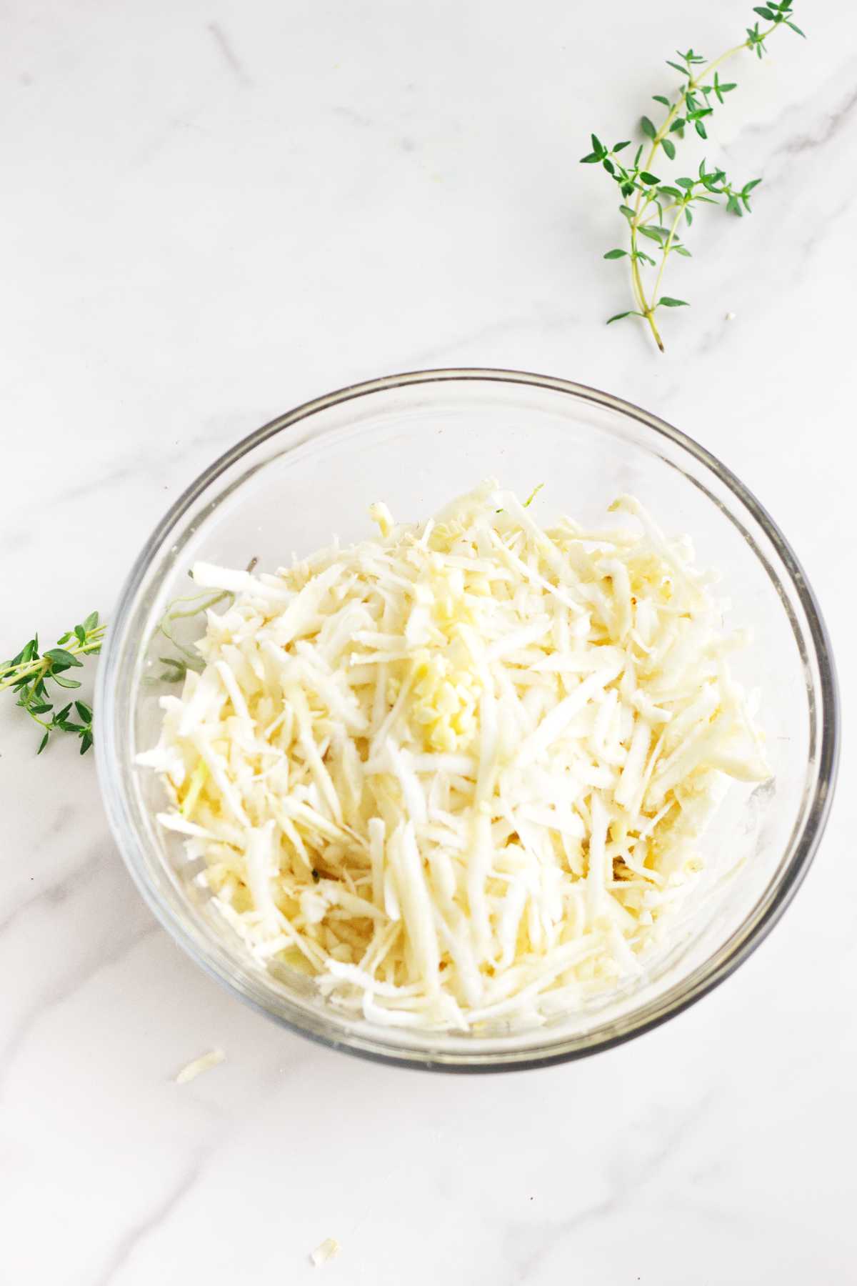 shredded celery root in a bowl.