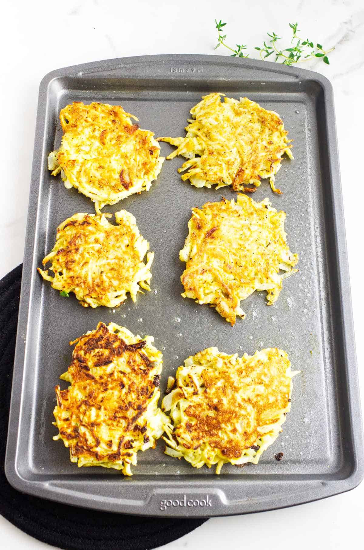 browned latkes on a baking sheet.