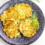 celery root latkes, low carb latkes, with sour cream on a serving platter.