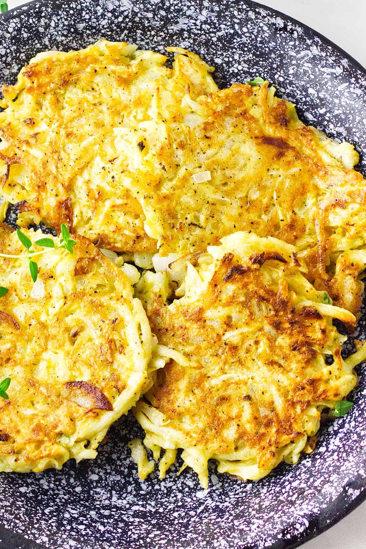 celery root latkes, low carb latkes, with sour cream on a serving platter.