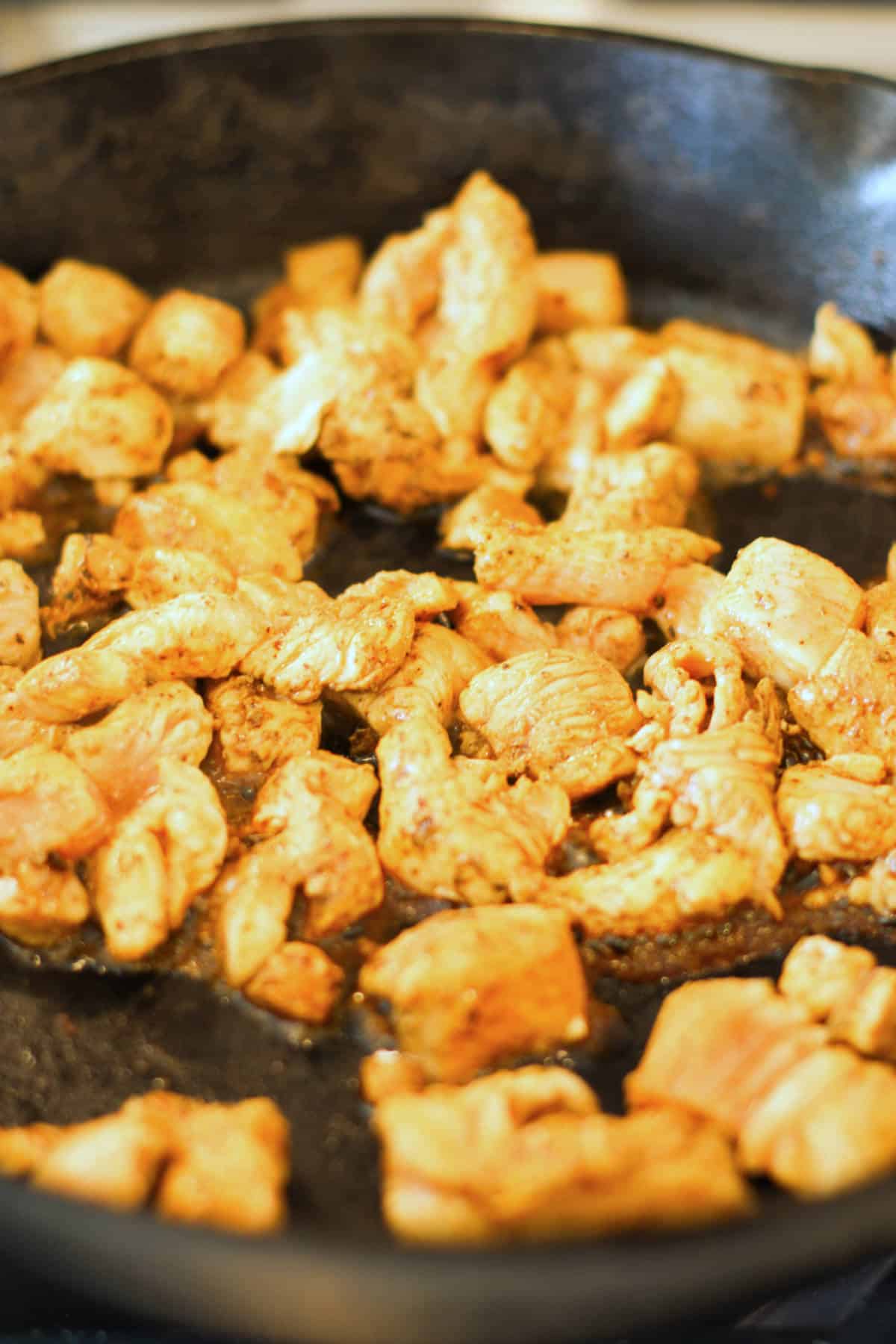 sauteed chicken in a cast iron skillet.
