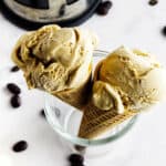 homemade coffee ice cream in cones with a French press in the background.