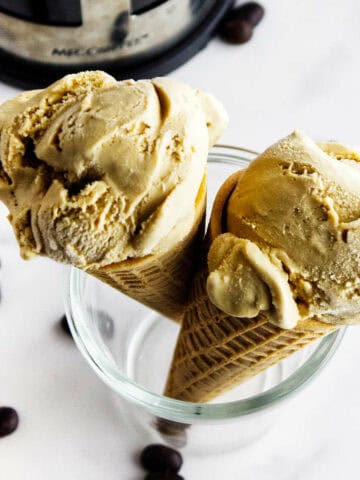 homemade coffee ice cream in cones with a French press in the background.