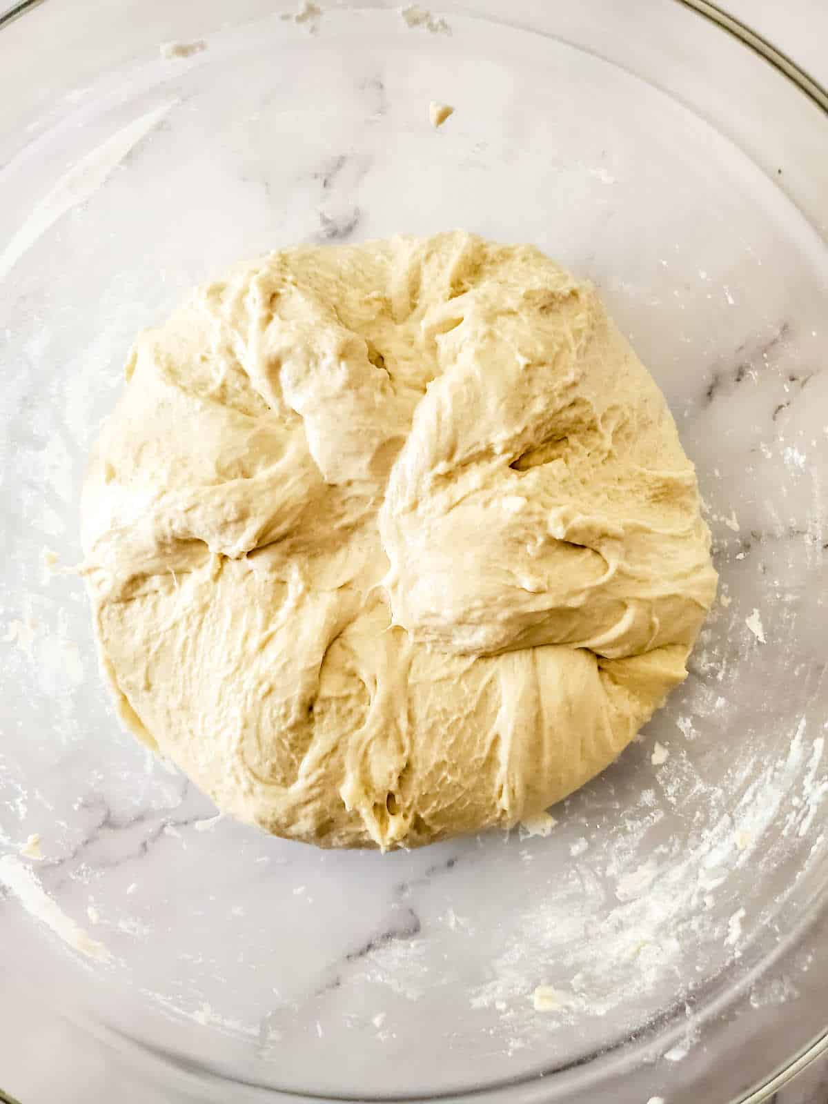 Setting dough in an oiled bowl to bulk rise.