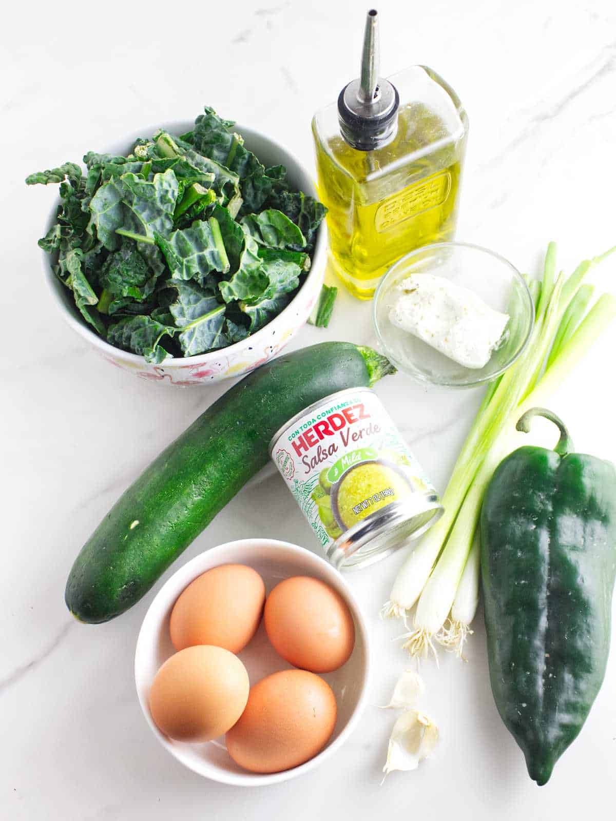 ingredients for a green pepper, poblano chili, kale, and zucchini shakshuka.