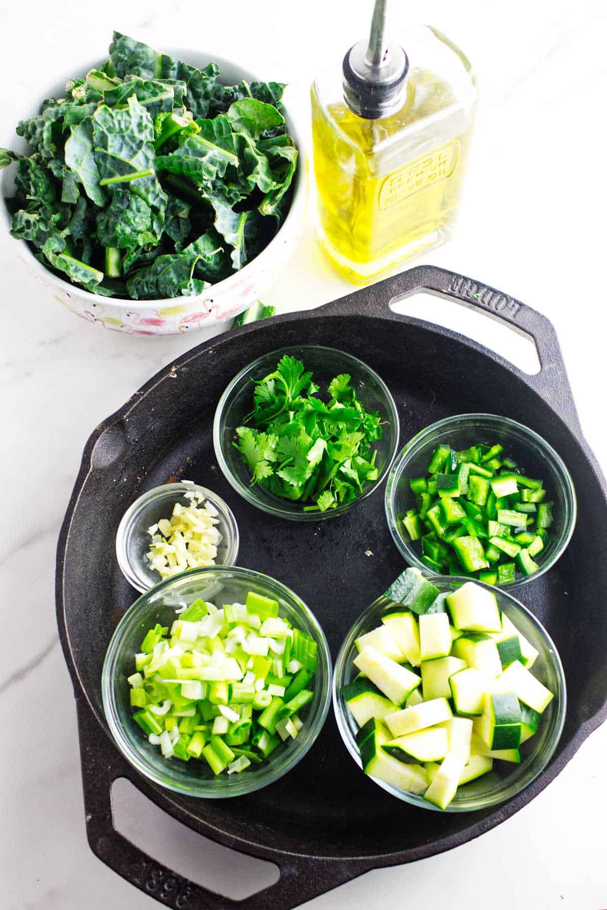 bowls of chopped green vegetables for making a green shakshuka.