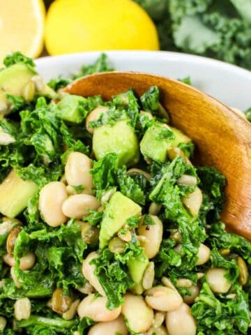 kale and white bean salad with avocado and lemon dijon dressing.