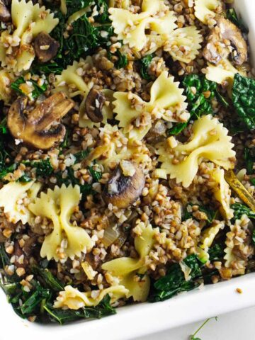 serving bowl of kasha varnishkes with mushrooms and kale.