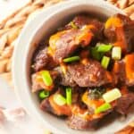 bowl of Korean beef bulgogi with Japanese yum yum sauce drizzled on top.