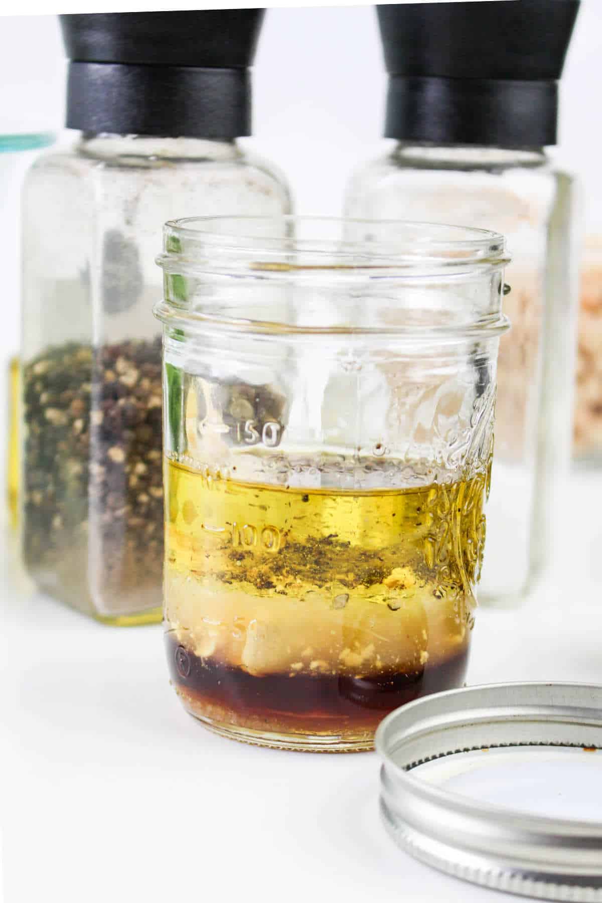 salad vinaigrette ingredients in a small mason jar.