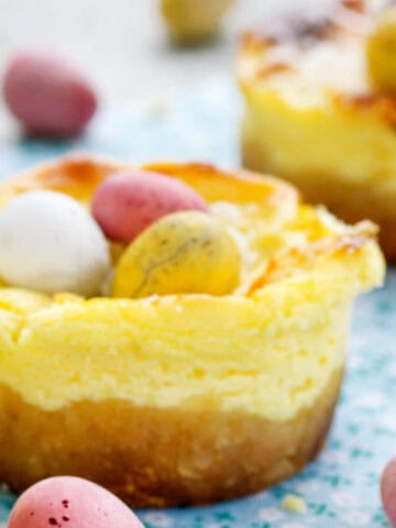 Mini Easter cheesecakes with candy eggs on top.