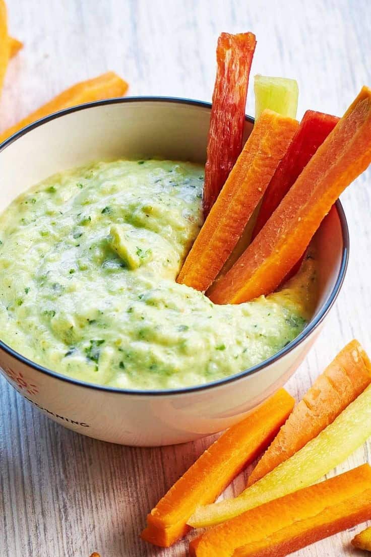 Roasted zucchini hummus with carrot sticks and crackers.