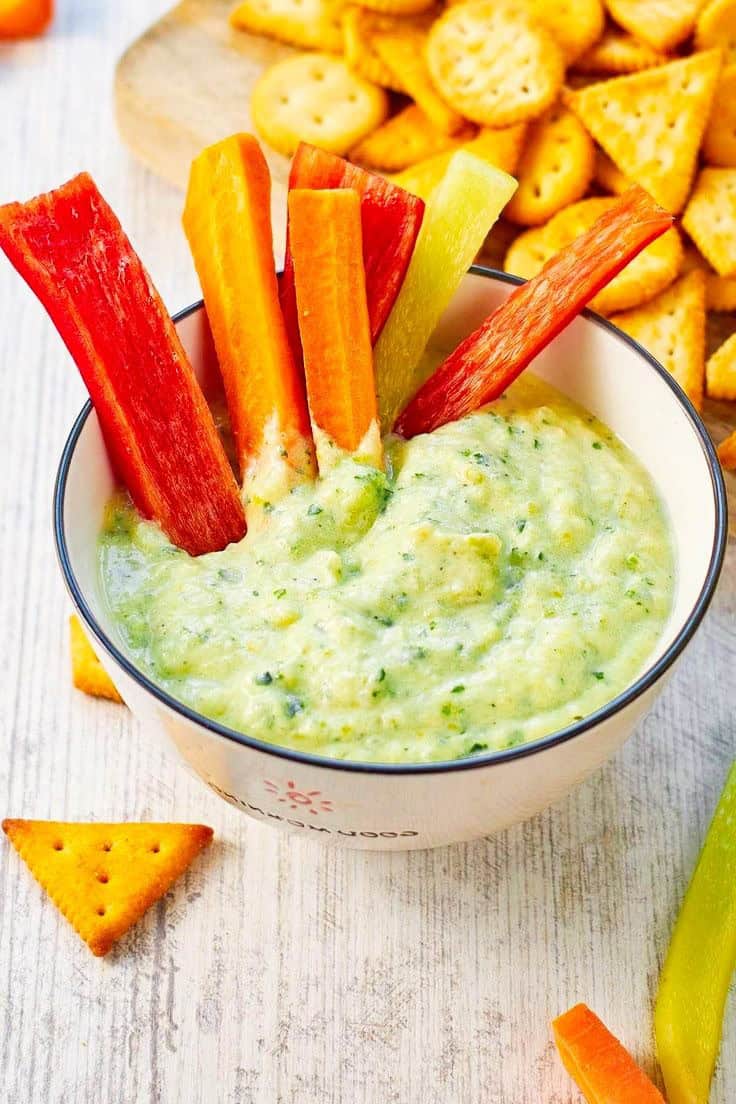 Roasted zucchini hummus with carrot sticks and crackers.