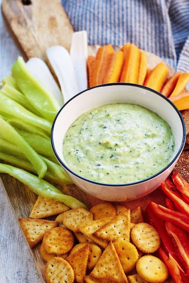 Roasted zucchini hummus with carrot sticks and crackers.