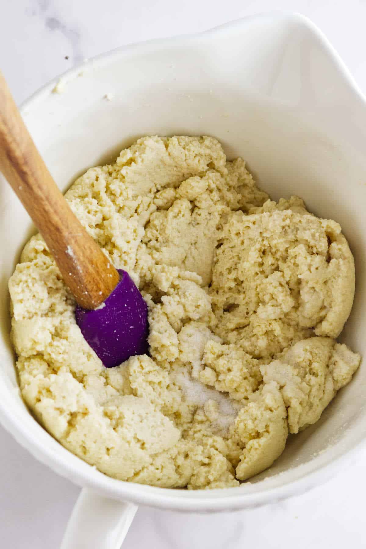 mixing semolina mash with ingredients for making bread.