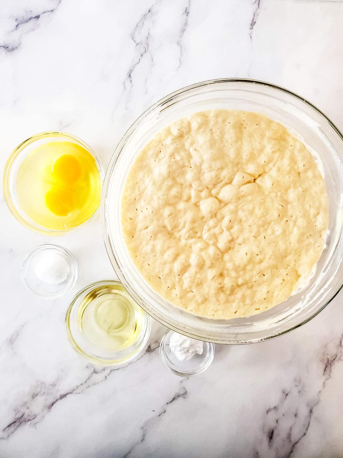 bowl of eggs, sourdough starter, and pancake batter ingredients.