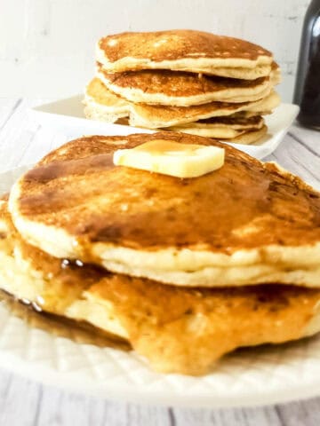 stack of sourdough discard pancakes with butter and syrup.