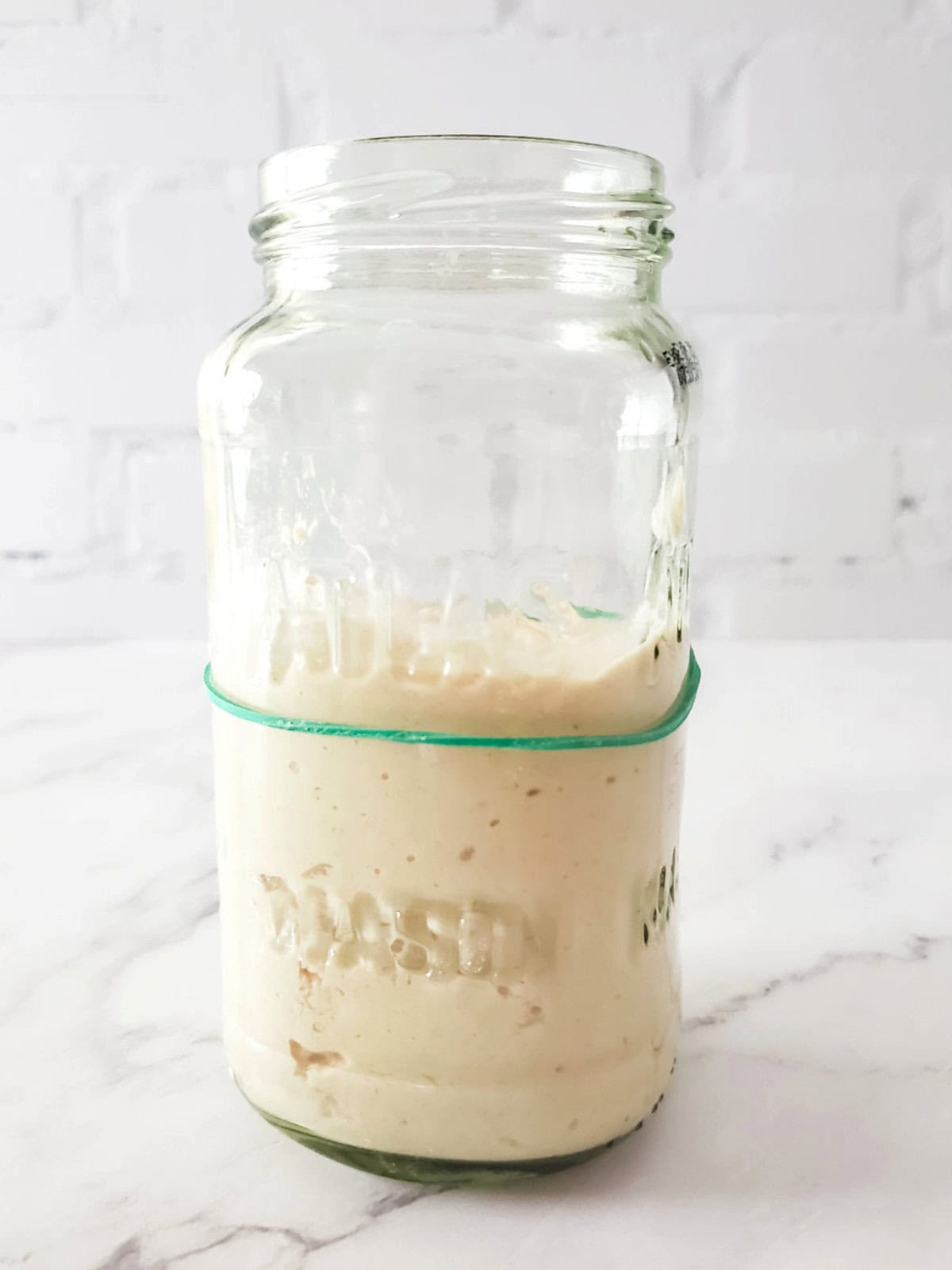 growing sourdough fermentation rising above the rubber band marker.