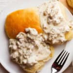 Southern White gravy covered biscuit on a plate.