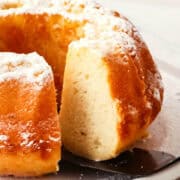 Vanilla Bundt cake with slice cut out.