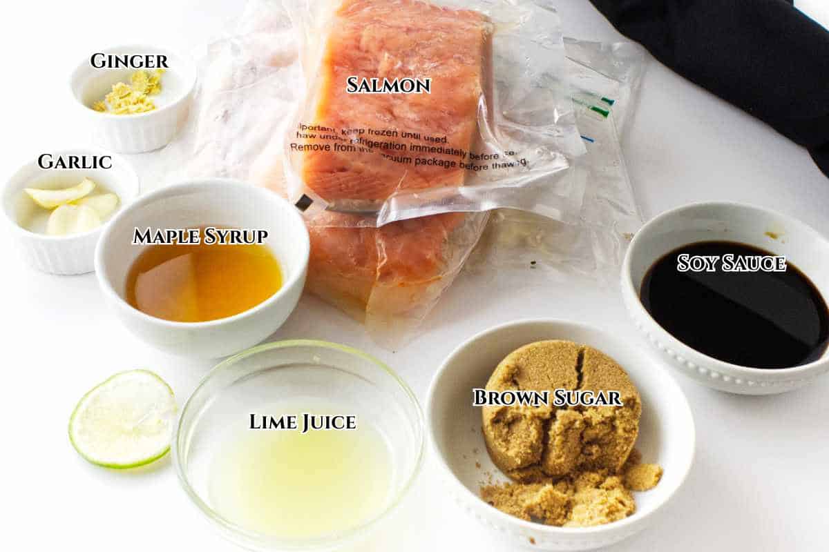 Ingredients for maple glazed salmon including salmon fillets, garlic, ginger, soy sauce, and brown sugar.