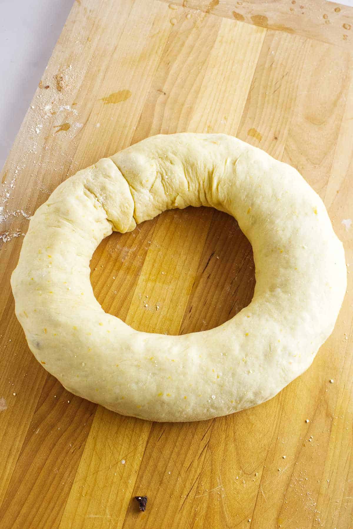 Rolled Rosca de Reyes dough shaped into a wreath before the second rise.