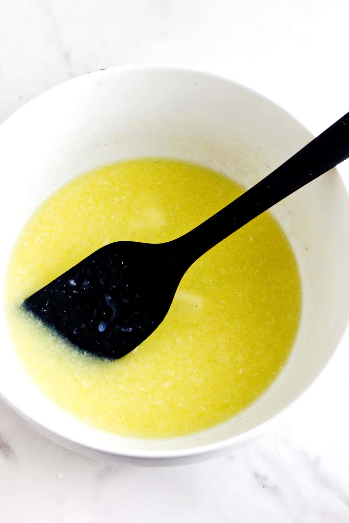 Warm milk and melted butter mixture cooling before being added to Rosca de Reyes dough.