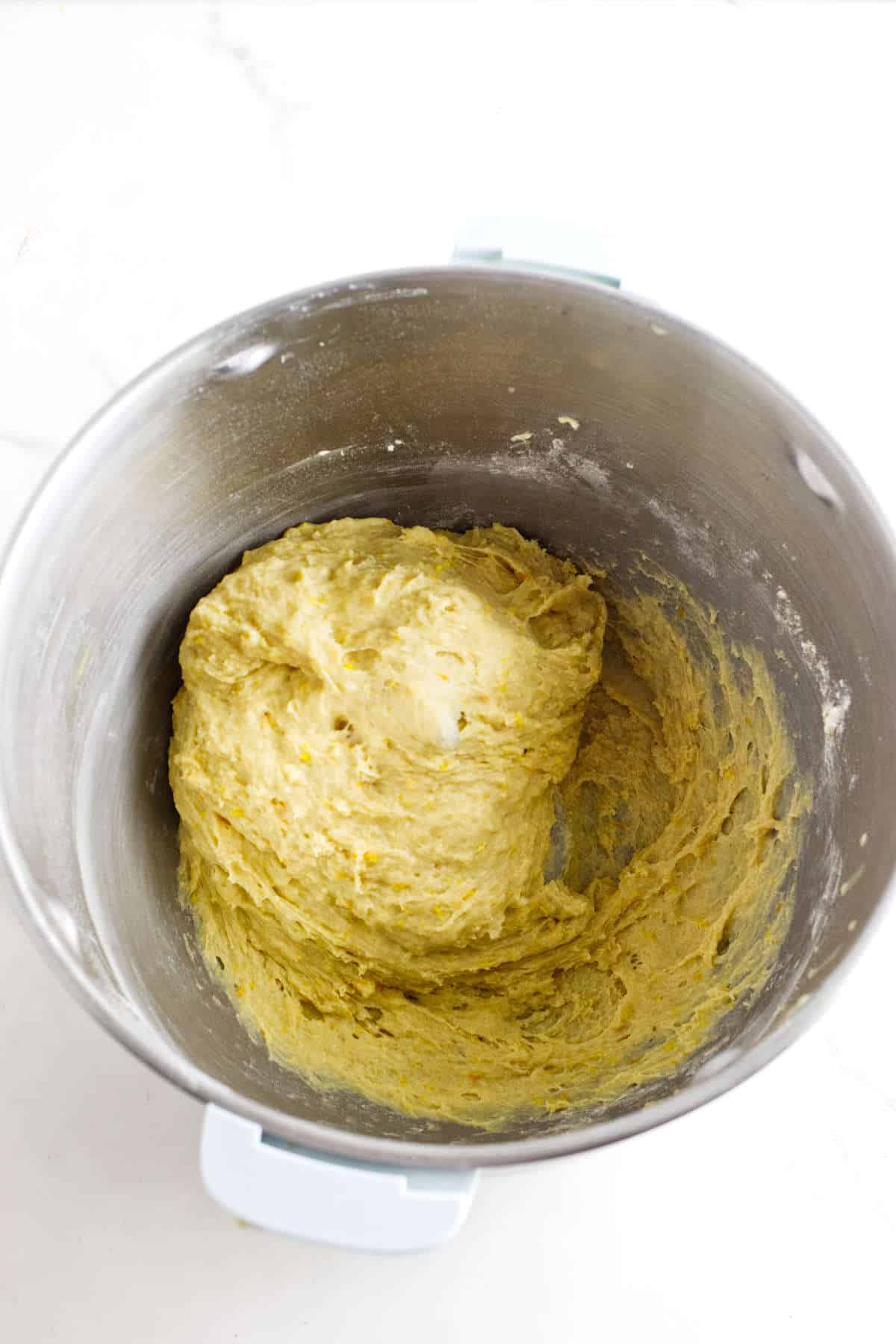 Sticky enriched dough mixed in a metal bowl for Rosca de Reyes.