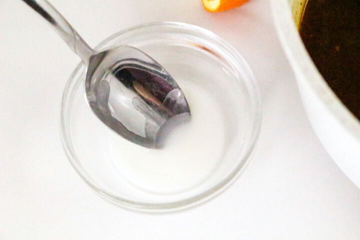 Cornstarch slurry being mixed in a small bowl.
