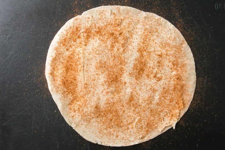 Flour tortilla sprinkled with Cajun seasoning for steak quesadillas.
