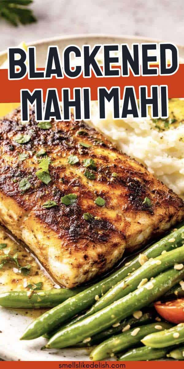 Two baked, seasoned fish fillets in a white dish, garnished with lemon slices. The fish has a golden-brown spice coating, and the background is light and minimal.