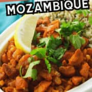 A white dish filled with Chicken Mozambique, garnished with fresh cilantro and a lemon wedge, served alongside seasoned rice. Text overlay reads "Chicken Mozambique" and "smellslikedelish.com".