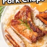 A plate with orange-glazed pork chops on white rice, garnished with rosemary, served with sweet potato wedges and orange slices. Text reads "Orange Glazed Pork Chops" and "smellslikedelish.com.
