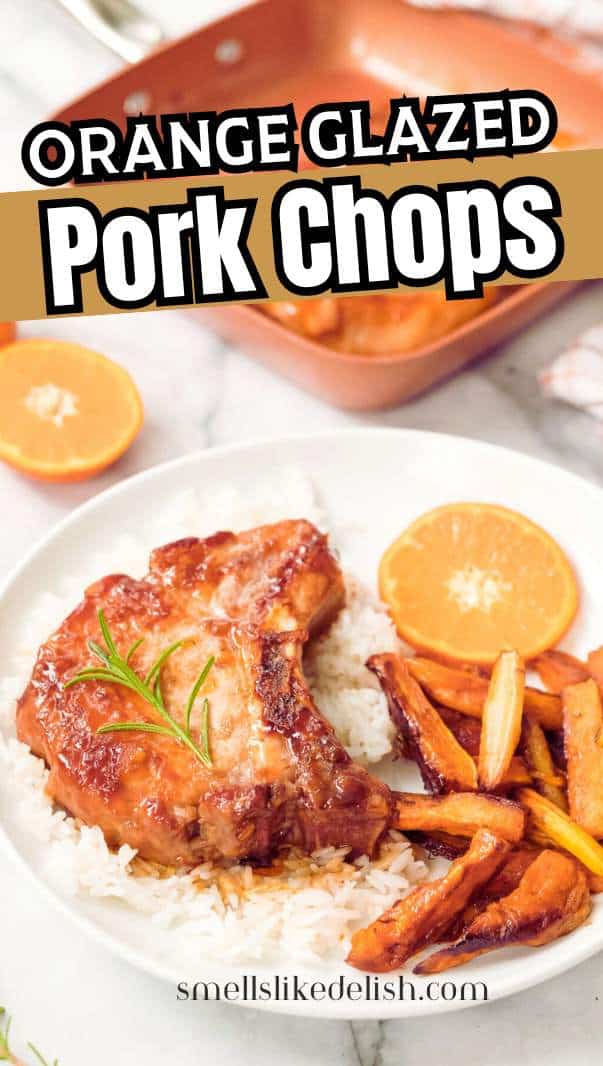 A plate with orange-glazed pork chop on white rice, roasted carrots, and orange slices. In the background, a copper skillet and a fork are visible. Text reads "Orange Glazed Pork Chops.