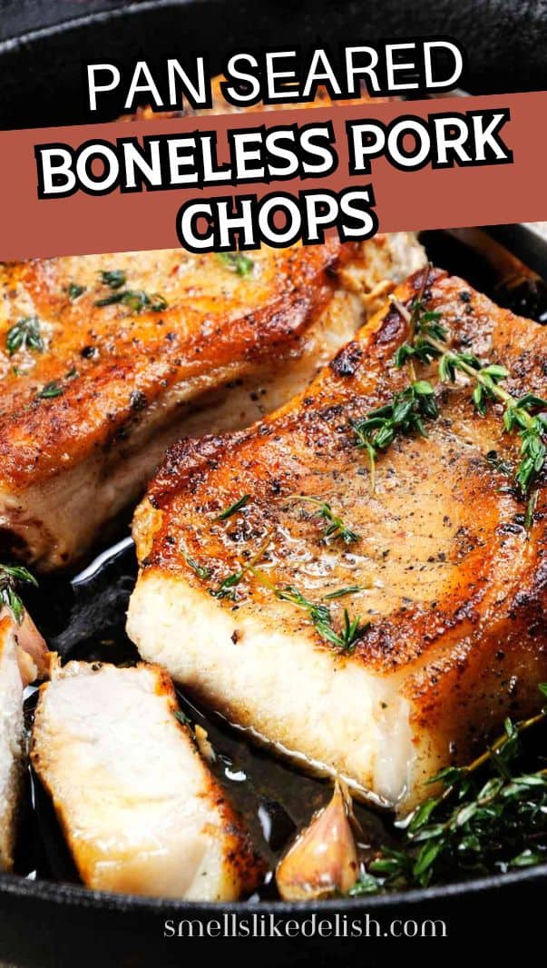 Juicy, pan grilled pork chops on a bone in oil with garlic and herbs in a frying pan.