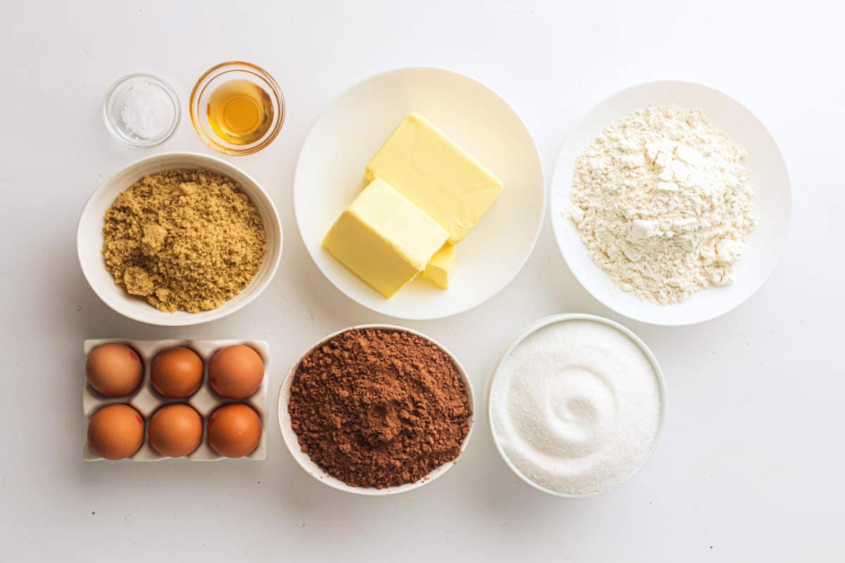 Ingredients for sheet pan brownies including butter, cocoa powder, sugar, eggs, flour, and vanilla..