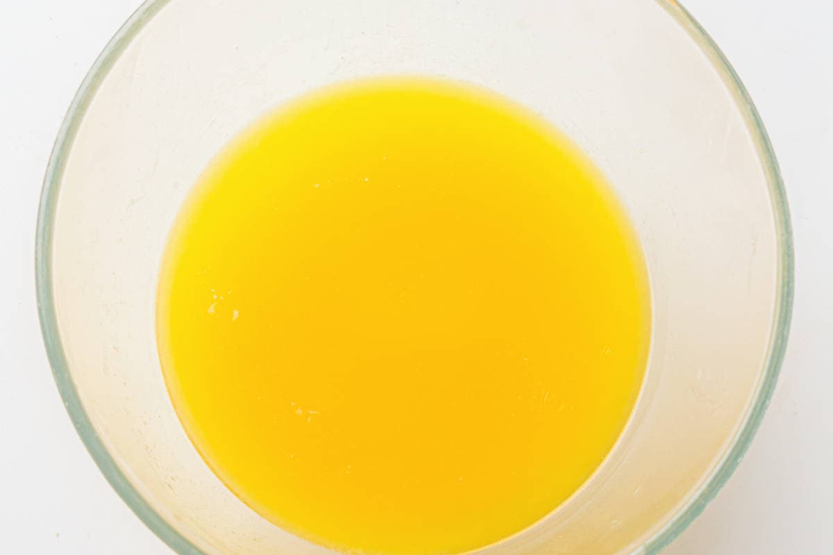 Melted butter in a bowl for making sheet pan brownies.