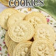 Delicious stamped shortbread cookies with floral patterns on a decorative plate.