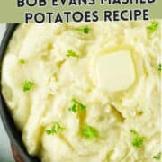 A bowl of creamy mashed potatoes topped with a pat of butter and garnished with parsley, with text overlay reading "Copycat Bob Evans Mashed Potatoes Recipe.