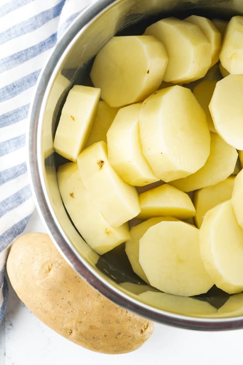 Peeled and sliced russet potatoes placed in an Instant Pot for copycat Bob Evans mashed potatoes.