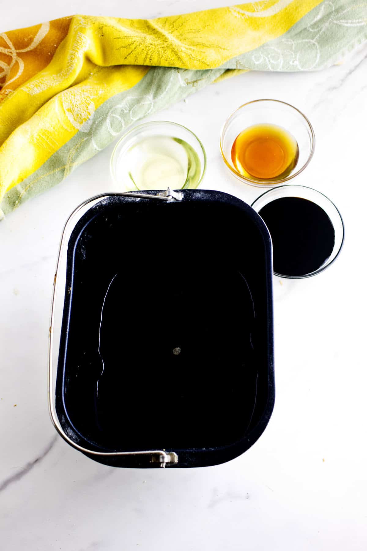 Bread machine pan with wet ingredients added.