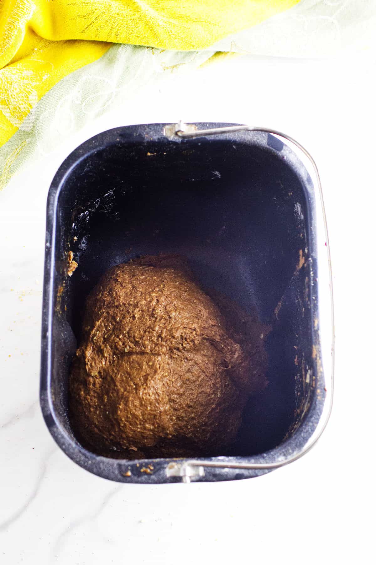 Bread dough after mixing inside bread machine pan.