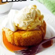 A round butter cake topped with a scoop of vanilla ice cream and whipped cream sits on a white plate with caramel sauce, a fork, and part of a green napkin visible. Text reads "Del Frisco's Butter Cake.