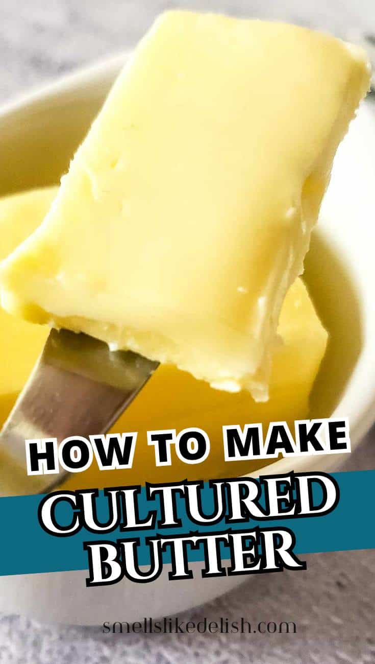 A close-up of a knife holding a thick slice of creamy butter over a small white bowl, with text overlay: "How to Make Cultured Butter" and "smellslikedelish.com" at the bottom.