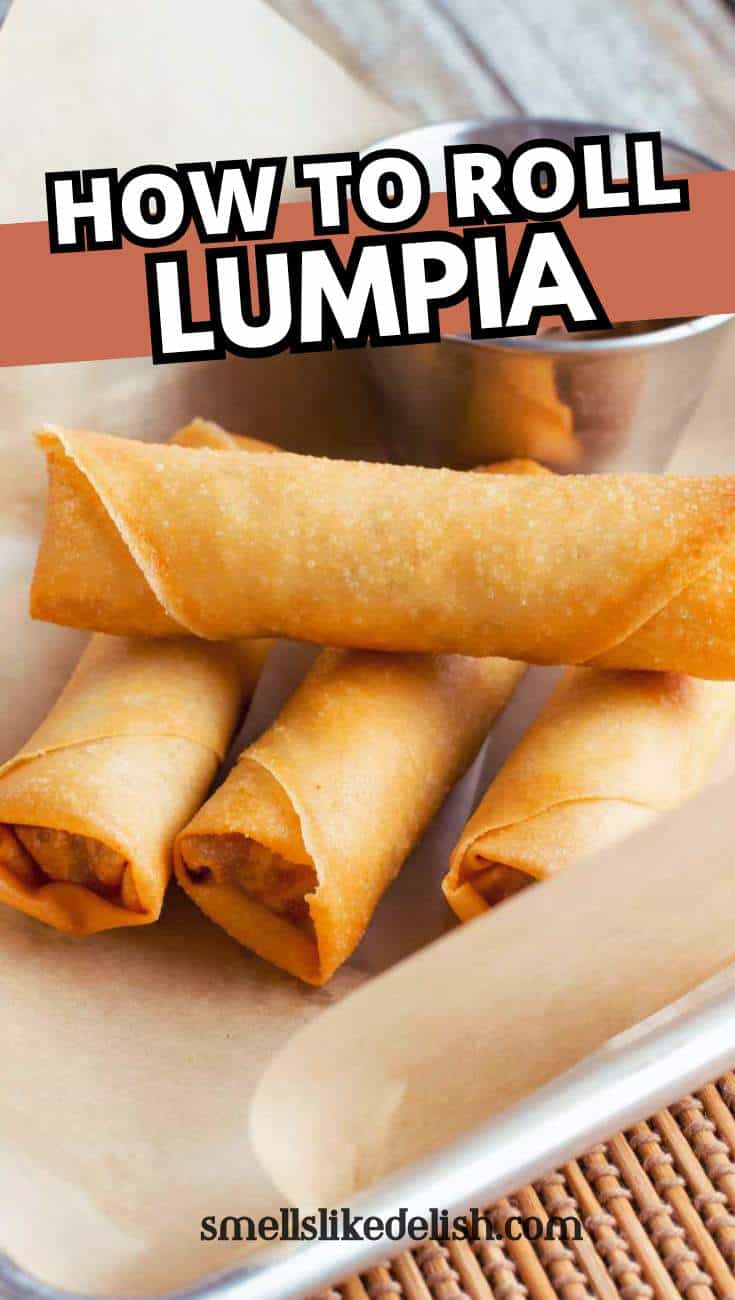 Three golden-brown lumpia rolls are arranged on parchment paper in a tray, with a metal dipping sauce container in the background. Text on the image reads “How to Roll Lumpia.”.