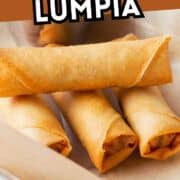 Three golden-brown lumpia spring rolls on parchment paper, with two stacked and one resting beside them. Bold text at the top reads “How to Roll Lumpia.”.