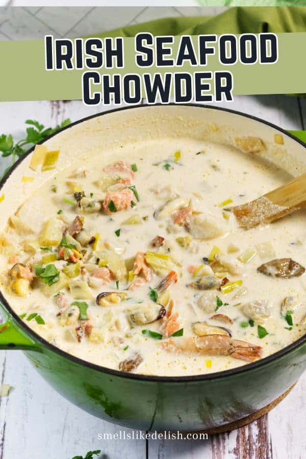 A large green pot filled with creamy Irish seafood chowder, featuring chunks of fish, shellfish, potatoes, and herbs, with a wooden spoon resting inside. The text "Irish Seafood Chowder" is at the top.